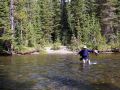 Backpacker crossing the Bechler River