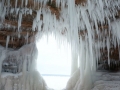 Keyhole in cave wall surrounded by icicles
